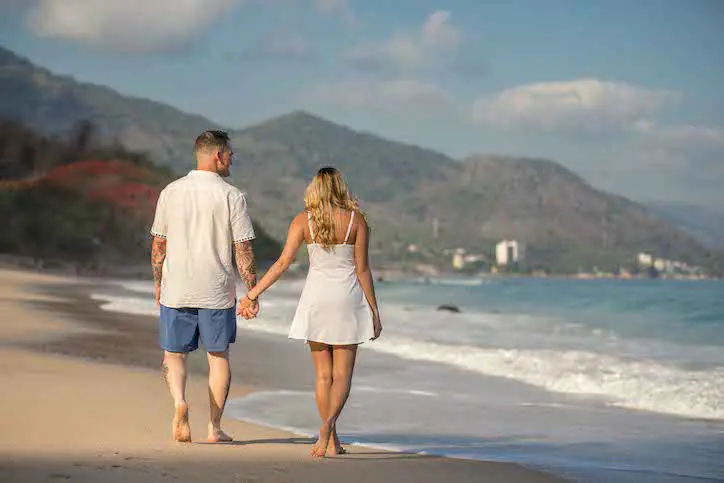 Couple walking along the Playa Punta Negra in Nayarit Mexico
