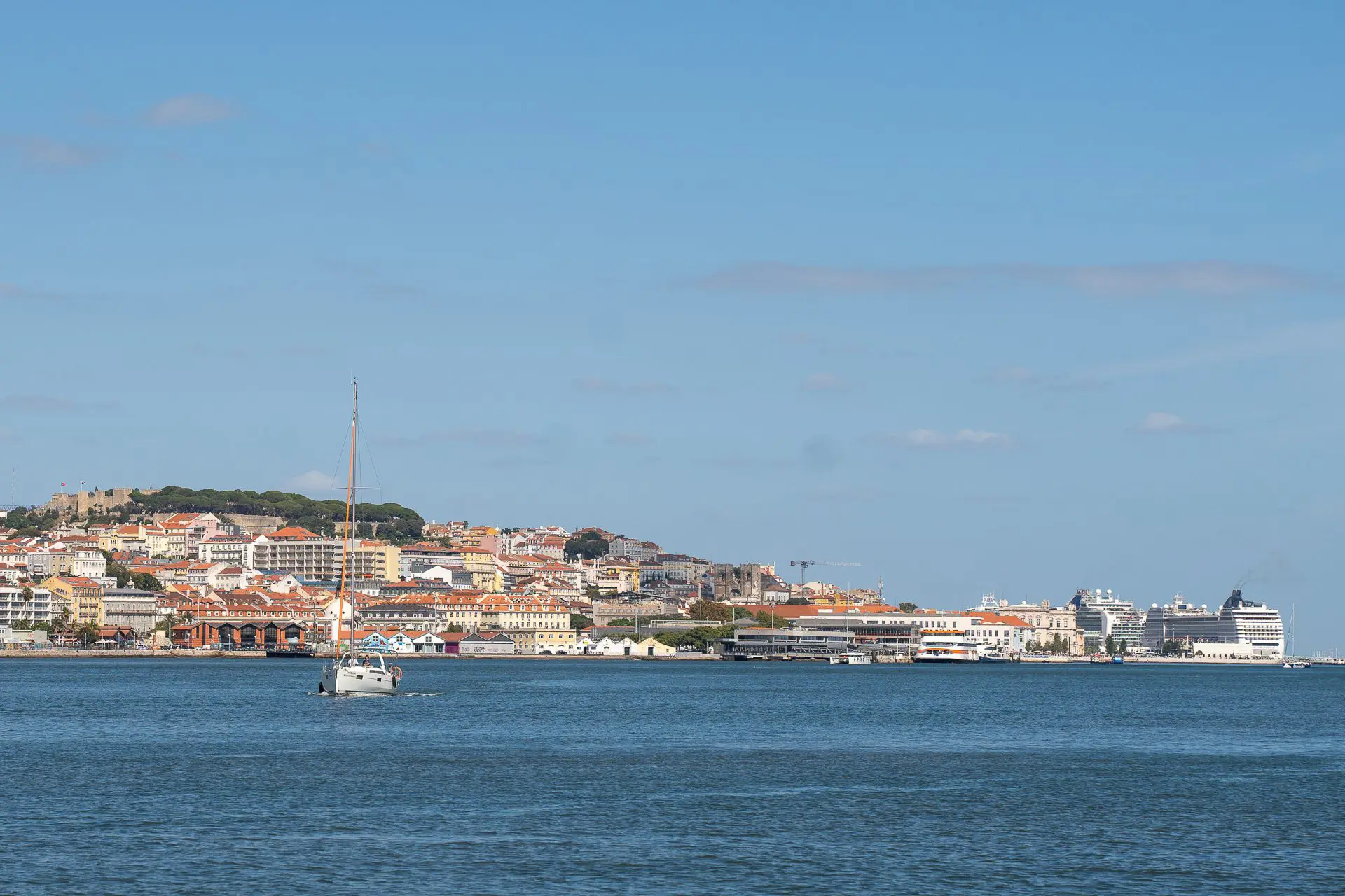 Paseo en barco por el río Tajo, mostrando a los asistentes disfrutando de las vistas panorámicas de Lisboa.