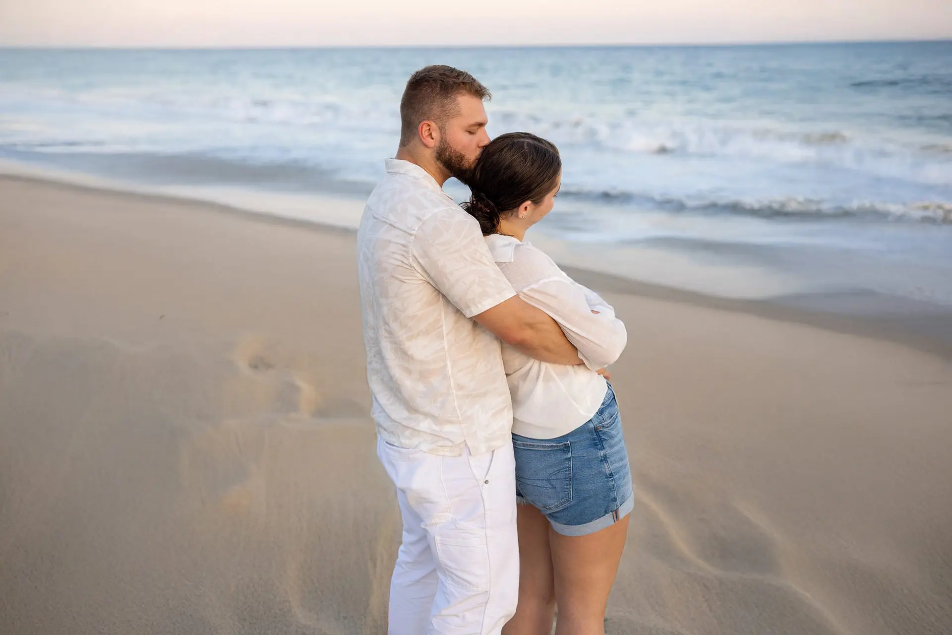A couple holding each other while on the beach at the Hyatt Ziva Los Cabos