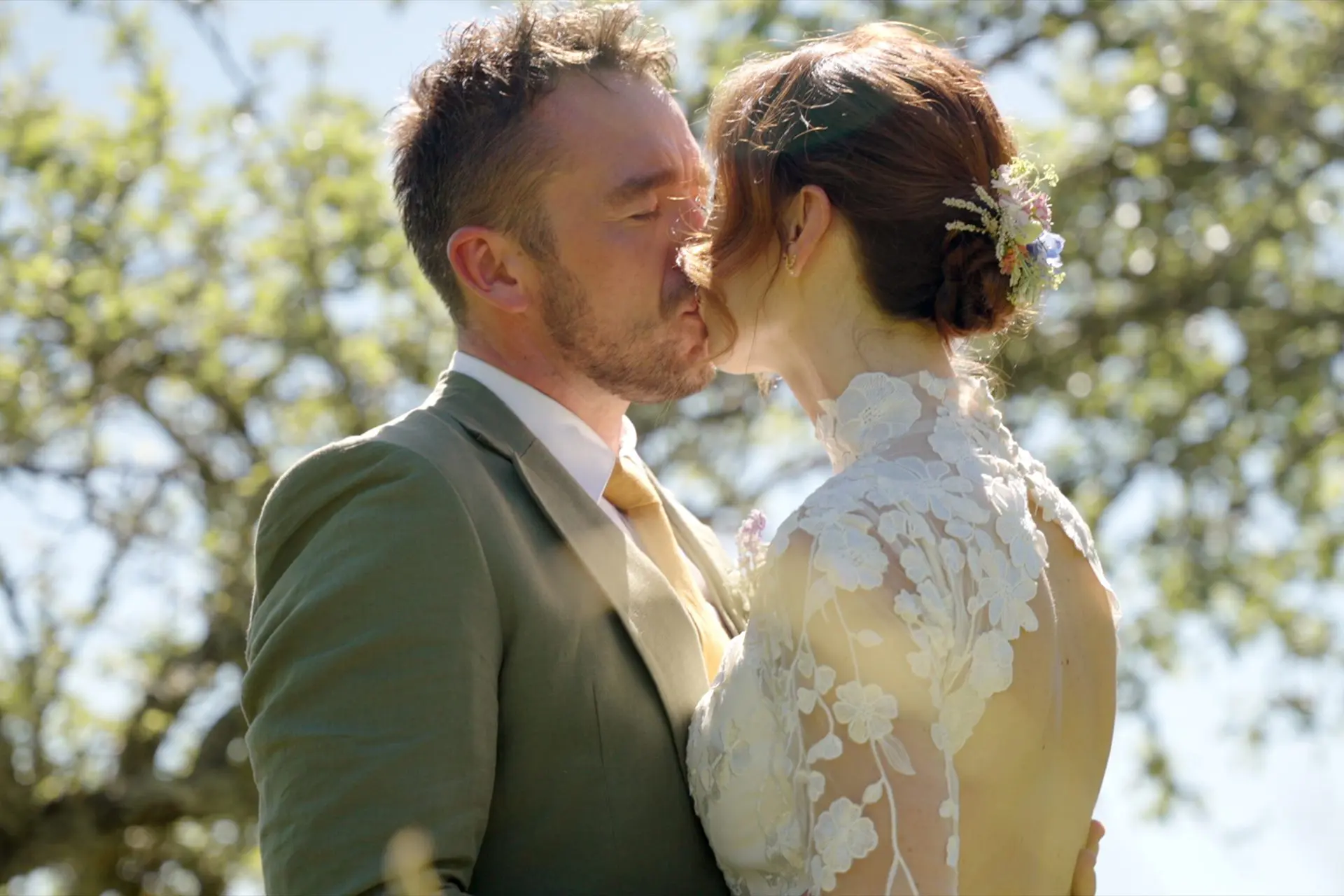 Bride and groom kiss in the French countryside