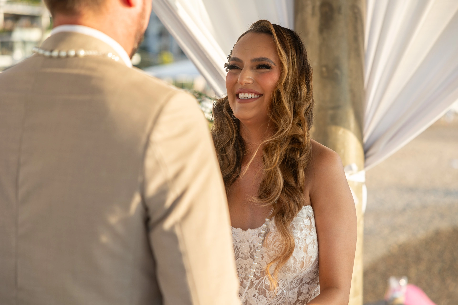 Bride smiles while exchanging vows with groom at their Lisbon wedding